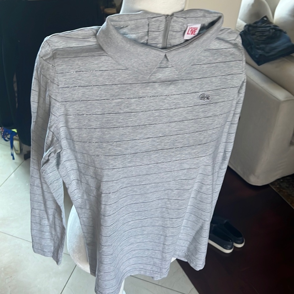 Adorable Lacoste long sleeve tee with collar and zip closure in back. Size S.